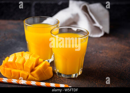 Freschi di succo di mango su sfondo scuro Foto Stock