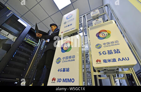 Un lavoratore cinese prove attrezzature a Tianjin prima del 5G la stazione base in China Mobile joint innovation center di Tianjin laboratorio aperto di Tianjin, C Foto Stock