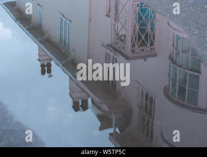 Lyme Regis, Dorset, Regno Unito. Il 30 luglio 2019. Regno Unito: Meteo dopo giorni di sole splendente, Pesanti rovesci di pioggia ha colpito la stazione balneare di Lyme Regis segnando una pausa per la canicola di luglio. I pittoreschi cottage che la linea Marine Parade si riflettono nelle pozzanghere dopo una notte di pioggia pesante. Credito: Celia McMahon/Alamy Live News. Foto Stock