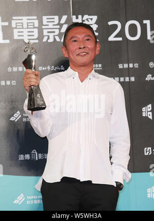 **TAIWAN OUT * * Taiwanese regista Doze Niu pone con il suo trofeo durante il XVII Taipei Film Festival di Taipei, Taiwan, 18 luglio 2015. Taiwan ac Foto Stock