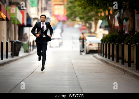 Imprenditore sorridente la scrittura su un blocco note. Foto Stock