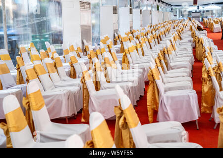 Temporanea di condizionatore aria tenda interna per eventi esterni nel giorno. All'interno tende ha moquette rossa e un sacco di sedia coperta da un panno bianco e golde ri Foto Stock