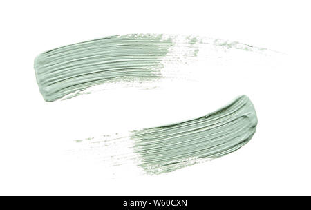 Delicatamente pennellate di colore verde e la consistenza di crema per il viso o vernice acrilica isolati su sfondo bianco Foto Stock