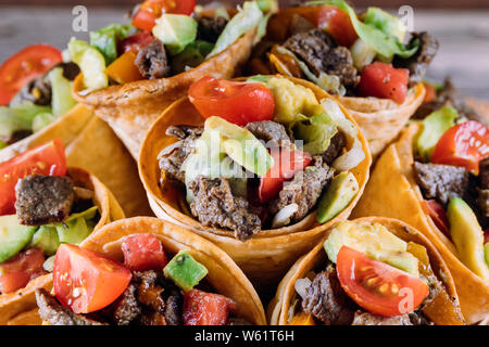 Insalata di manzo in taco coni con peperoni, pomodori e avocado Foto Stock