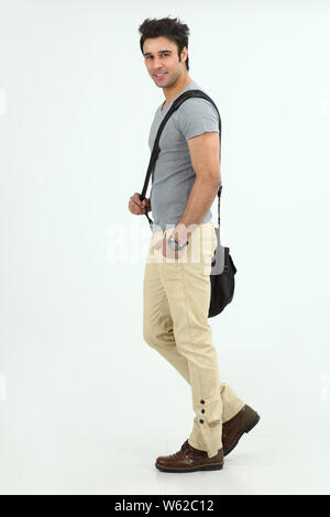 College student walking with a bag Stock Photo