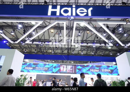 --FILE -- la gente visita lo stand della Haier durante una mostra a Shanghai in Cina, 26 luglio 2018. Chinese consumer electronics company Haier elettrodomestici Foto Stock