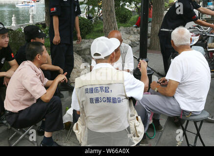 --FILE--anziani persone locali chat assieme su una strada di Shichahai Scenic Area a Pechino in Cina, 15 settembre 2016. La speranza di vita media di B Foto Stock