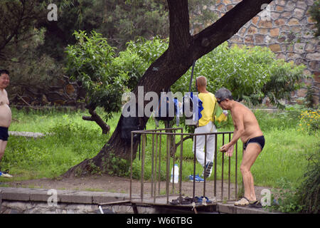 Locale gli amanti del nuoto sono visti vicino al laghetto del palazzo d'estate, ignorando la lettura di avvertimento "Primo Livello Acqua Potabile fonte; non si può nuotare' in essere Foto Stock