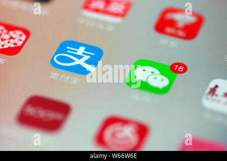 --FILE--un cinese telefono cellulare utente guarda le icone delle app di Alipay, sinistra, il servizio di pagamento online di cinesi e-commerce giant Alibaba è un Foto Stock