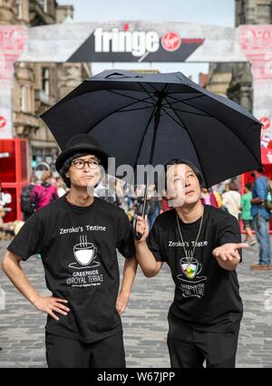 Edinburgh, Regno Unito. 31 Luglio, 2019. Anteprime per la Edinburgh Fringe Festival inizia con l'avvio ufficiale data del 2 agosto. Gli artisti interpreti o esecutori Zeroko's Teatime speranza che la pioggia farà stare lontano come essi eseguono sul Royal Mile. Credito: ricca di Dyson/Alamy Live News Foto Stock