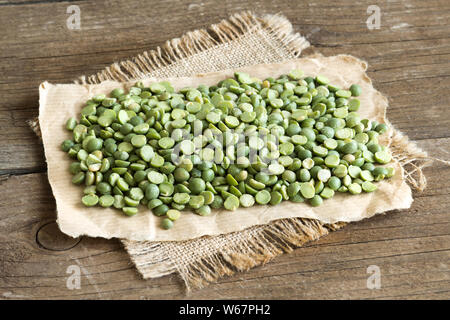 Verde secchi Piselli spezzati su un tavolo di legno Foto Stock