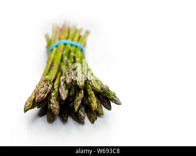 Giardino fresco, closeup di un fascio di sano asparagi di primavera spears su tela bianca tovaglia. Copia dello spazio. Foto Stock