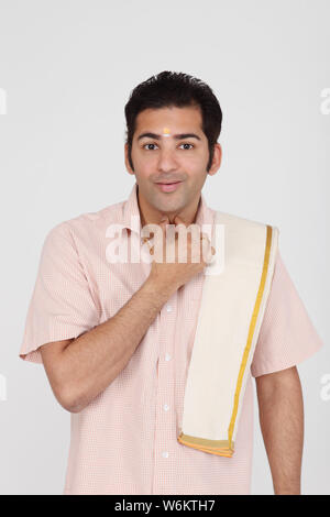 Sudindiano uomo giurando con la mano sul collo Foto Stock