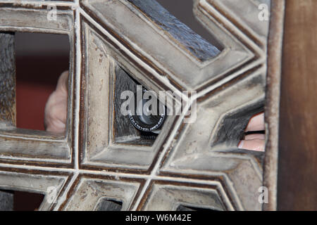 Tourist taking photograph behind a window Stock Photo