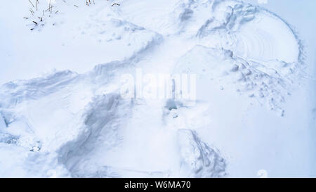Close up della coperta di neve terreno in inverno con un angelo di neve Foto Stock