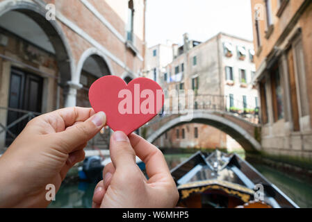 Close-up del giovane Mani forma di cuore mentre cavalcate in Gondola a Venezia Foto Stock