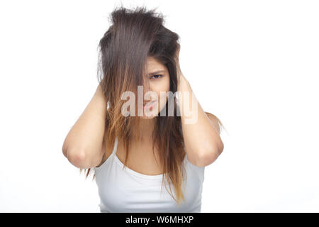 Young woman frustrated with her tangled hair Stock Photo