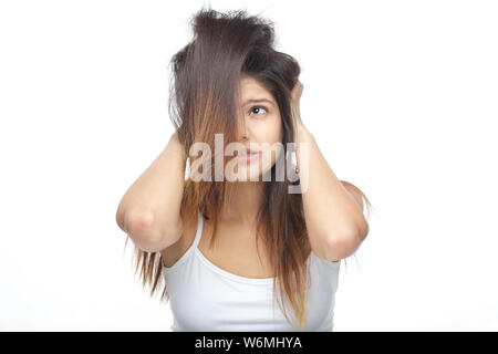 Young woman frustrated with her tangled hair Stock Photo