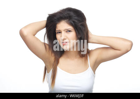 Young woman frustrated with her tangled hair Stock Photo