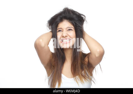 Young woman frustrated with her tangled hair Stock Photo