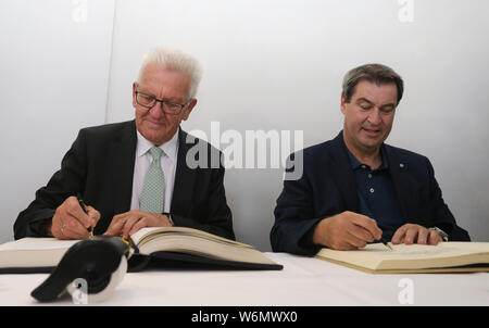 23 luglio 2019, Baden-Wuerttemberg, Meersburg: Winfried Kretschmann, primo ministro del Land Baden-Württemberg (Verdi,l) e Markus Söder, il Primo Ministro bavarese (CSU) firmare i libri della città e lo stato. Foto: Karl-Josef Hildenbrand/dpa Foto Stock