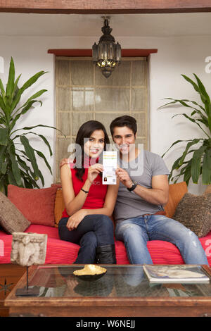 Young couple holding an Aadhar card at home Stock Photo