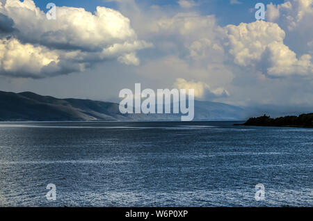 Vista del cielo, oscurato da enormi cumuli di nuvole provenienti dalle montagne e appeso sopra la montagna lago Sevan, situato nelle montagne di Armen Foto Stock