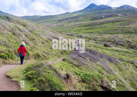 Walkers sul Il Pembrokeshire Coast National Park, sentiero costiero di seguito Carn Llidi tra Whitesands Bay e St Davids Testa, Wales, Regno Unito Foto Stock