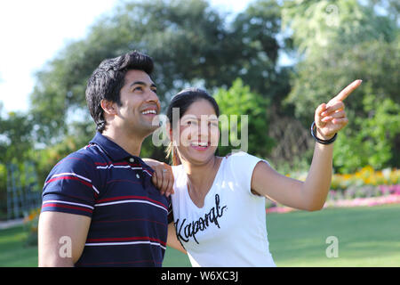 Woman showing something to her husband in a park Stock Photo