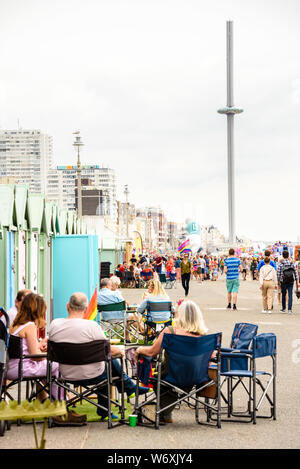 Brighton, East Sussex, Regno Unito. Il 3° agosto 2019. Brighton, Regno Unito. 03 Ago, 2019. Hove effettivamente - Visualizzazione di poltrona di fronte alla spiaggia di capanne con BA i360 in background durante il Brighton Pride Parade sui prati di Hove, Brighton East Sussex, Regno Unito. 3 agosto 2019 Photo credit: Julia Claxton/Alamy Live News Foto Stock