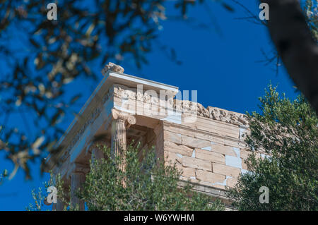 Tempio di Atena Nike sull'Acropoli sbirciando attraverso le foglie degli alberi, Atene, Grecia Foto Stock