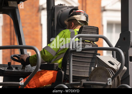 Operai telefoni folla le mani Foto Stock