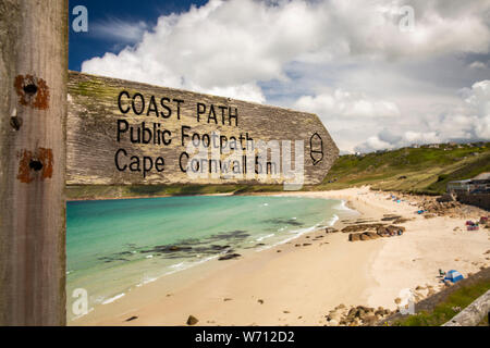 Regno Unito, Inghilterra, Cornwall, Sennen Cove, sentiero costiero segnaletica per Cape Cornwall sopra beach nella luce del sole Foto Stock