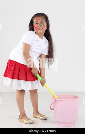 Ragazza che gioca Holi e sorridente Foto Stock