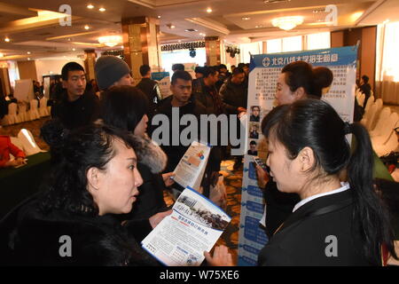 Il Cinese in cerca di lavoro parla con intervistatori in cerca di occupazione a una fiera del lavoro in città Heihe, a nord-est della Cina di Provincia di Heilongjiang, 22 Dicembre 20 Foto Stock