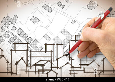 Architetto di disegno di un edificio residenziale su un immaginario mappa catastale del territorio con edifici, campi e strade Foto Stock