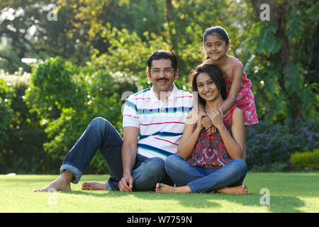 Family sitting together in a park Stock Photo