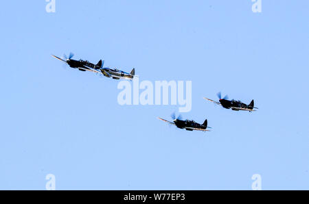 Un restaurato MK IX Spitfire (seconda a sinistra) decolla dall'aerodromo di Goodwood come IWC Schaffhausen argento Spitfire piloti Matt Jones e Steve Boultbee Brooks sta cercando di battere il piano denominato 'Silver Spitfire" in tutto il mondo nella prima circumnavigazione del globo da parte di uno Spitfire. Foto Stock