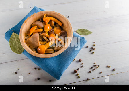 Decapare i funghi di utensili in legno su uno sfondo bianco Foto Stock