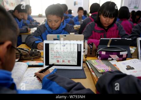 Gli alunni cinesi utilizzano Tablet PC come strumenti di apprendimento durante una lezione presso una scuola media nella Città di Zhengzhou, centrale cinese della provincia di Henan, 16 novembre 2017 Foto Stock