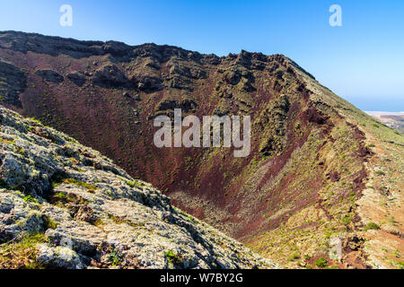 Spagna, Lanzarote, salendo del vulcano della Corona di montagna lungo il bordo del cratere. Foto Stock