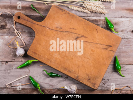 Vecchia cucina marrone scheda con pepe verde aglio e grano Foto Stock