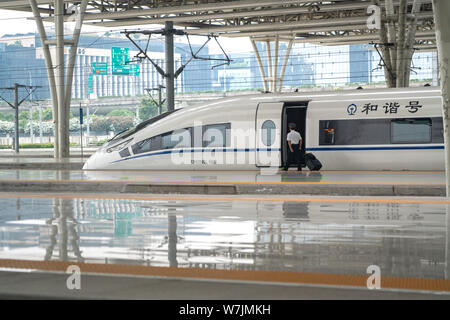 Treno veloce schede ingegnere la parte anteriore del treno come esso è fermo al Shanghai Hongqiao stazione ferroviaria in Cina a Shanghai. Foto Stock