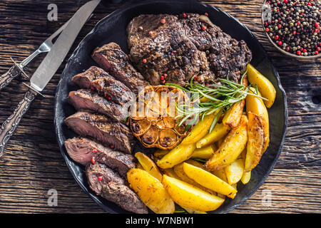 Manzo alla griglia Costata di manzo con aglio american patate Rosmarino sale e spezie Foto Stock