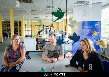 Oranienburg, Germania. 16 Luglio, 2019. Steffi Engels (l-r) e Ronny Kraemer, entrambi ex disoccupati di lunga durata, sedersi insieme con Jenny Riedel, titolare di azienda di mobili per ufficio di gestione, e dei formatori del supporto di integrazione per disoccupati di lunga durata e delle esigenze delle famiglie europee. Tra il 2015 e il 2020, circa 40 milioni di euro dai fondi europei del programma sarà disponibile per il Brandeburgo. Credito: Gregor Fischer/dpa/Alamy Live News Foto Stock