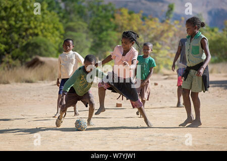 Ragazze e ragazzi che giocano a calcio, Anjaha comunitaria di conservazione Sito, vicino Ambalvao, Madagascar. Novembre 2014. Foto Stock