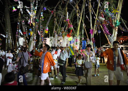 SHIMONOSEKI, Giappone - agosto 07: la gente a piedi con ornamenti tanabata presso il santuario composto durante l'annuale Festival Suhoutei Iminomiya al Santuario il 7 agosto 2019 a Chofu, Shimonoseki, prefettura di Yamaguchi, Giappone. La festa risale al II secolo, ogni anno la popolazione locale si riuniranno presso il santuario composto a camminare intorno a un gigante di pietra con molto alti labrums bambù attaccato al loro corpo durante la riproduzione attraverso i suoni di gong e tamburi taiko. Credito: Aflo Co. Ltd./Alamy Live News Foto Stock