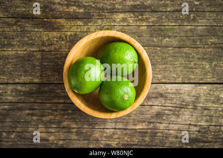 Il verde lime in ciotola di legno. Foto Stock
