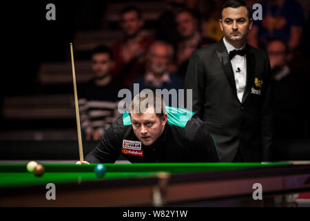 Mark Allen dell Irlanda del Nord considera un colpo a Marco fu di Hong Kong nel loro quarterfinal match durante il 2017 Dafabet Masters snooker tournamen Foto Stock