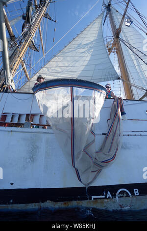 Gli scienziati abbassando il plancton net per investigare microplastics marini, da Corwith Cramer, un 134-piede brigantino in acciaio. Sargasso Sea, Bermuda, aprile 2014. Foto Stock